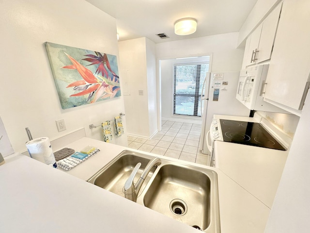 kitchen with white cabinets and light tile patterned flooring