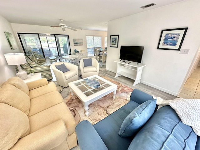 living room featuring ceiling fan and light hardwood / wood-style flooring