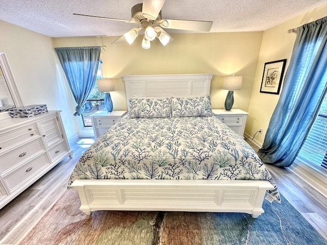 bedroom with ceiling fan and a textured ceiling