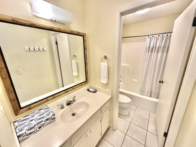 full bathroom featuring tile patterned floors, vanity, a textured ceiling, shower / bath combo with shower curtain, and toilet