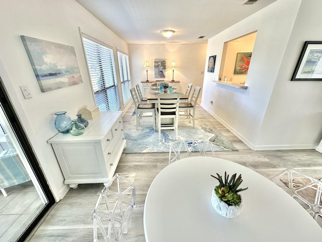 dining area featuring light wood-type flooring