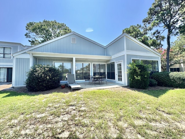 back of property featuring a yard and a patio