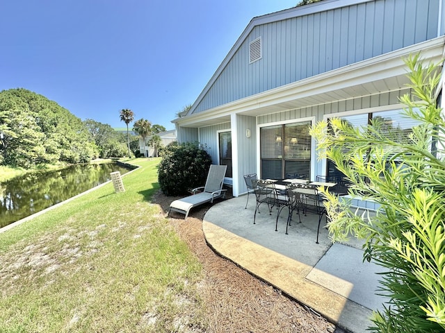 view of yard with a patio area and a water view