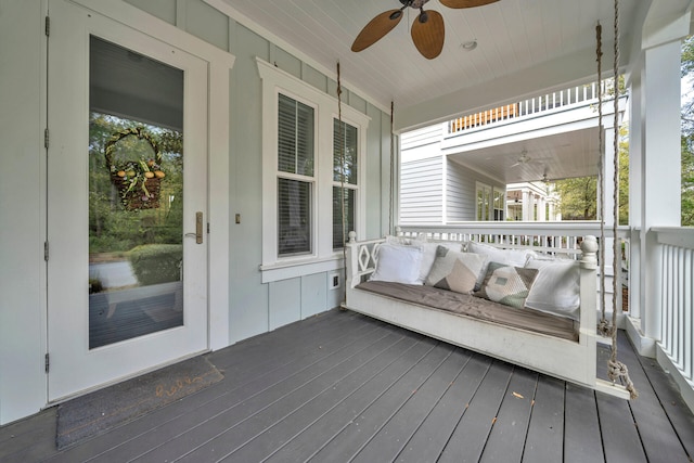 wooden deck featuring ceiling fan