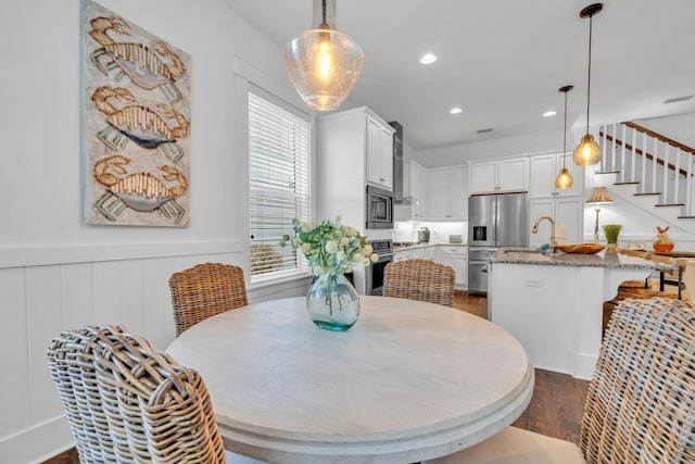 dining room with sink and dark hardwood / wood-style floors