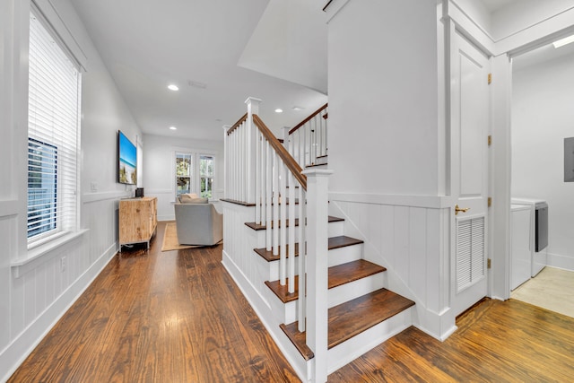 stairway featuring dark hardwood / wood-style floors and washer and dryer