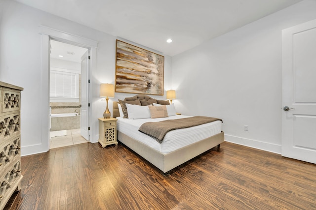 bedroom with connected bathroom and dark wood-type flooring