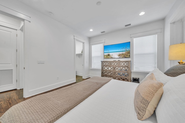 bedroom with dark hardwood / wood-style floors