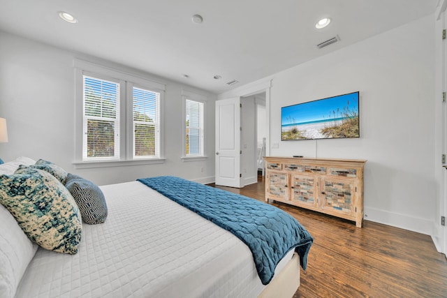 bedroom with dark hardwood / wood-style floors