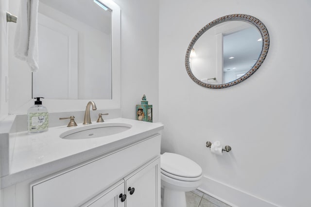 bathroom with oversized vanity, tile floors, and toilet