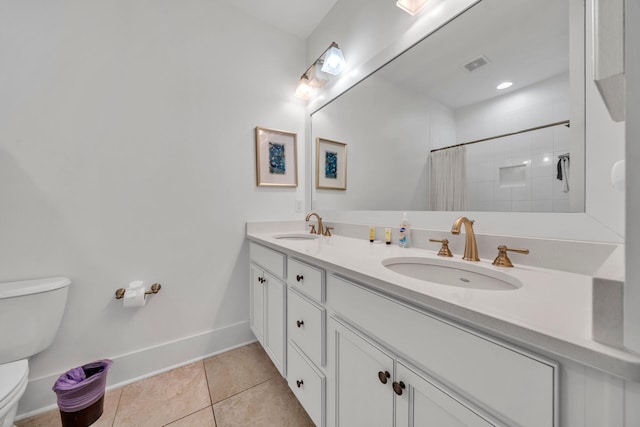 bathroom featuring dual bowl vanity, toilet, and tile flooring