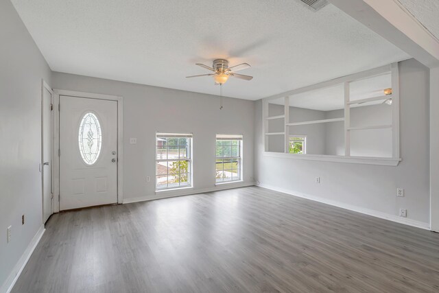 entrance foyer with ceiling fan, a textured ceiling, and hardwood / wood-style flooring