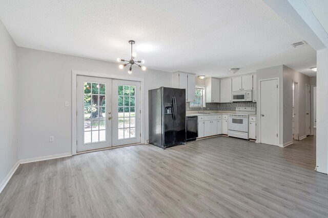 kitchen featuring french doors, backsplash, black appliances, light hardwood / wood-style flooring, and white cabinetry