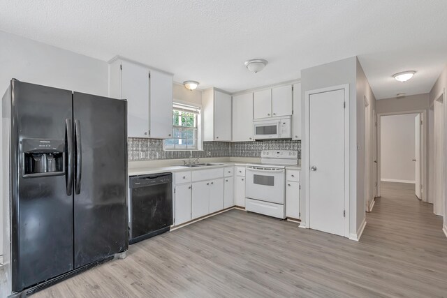 kitchen featuring white cabinetry, tasteful backsplash, light hardwood / wood-style flooring, a textured ceiling, and black appliances