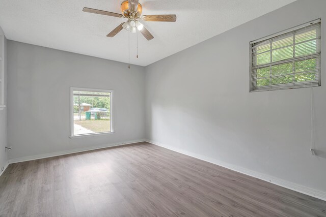 unfurnished room featuring ceiling fan and hardwood / wood-style floors