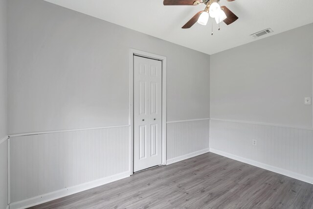 spare room with ceiling fan and light wood-type flooring