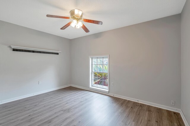 spare room with light hardwood / wood-style floors and ceiling fan