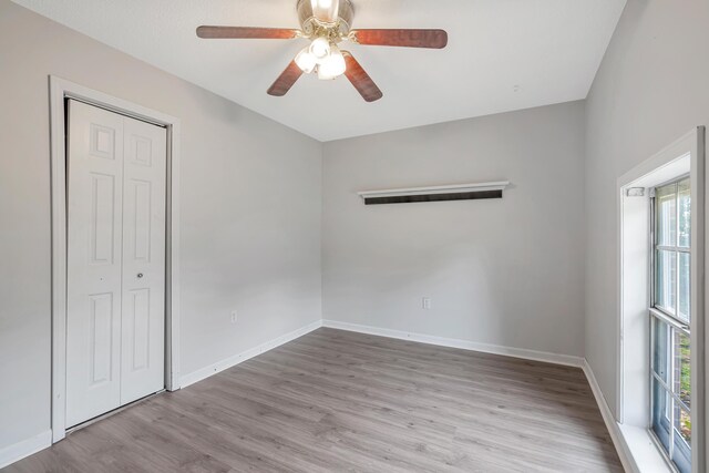 spare room featuring light hardwood / wood-style flooring and ceiling fan