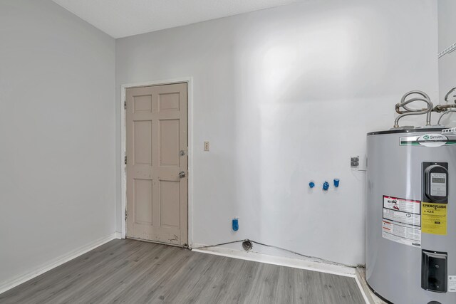 utility room featuring electric water heater