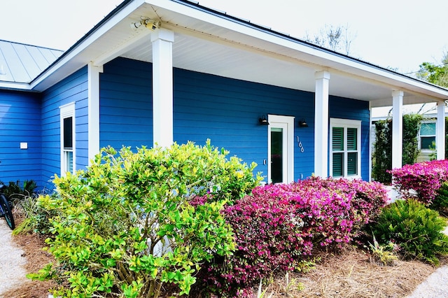 view of side of property featuring covered porch