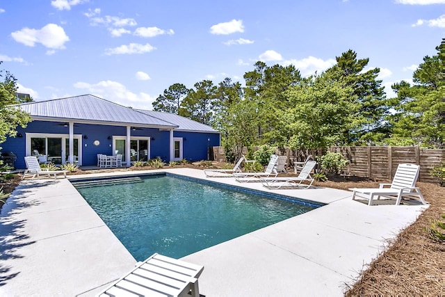 view of pool with a patio and ceiling fan