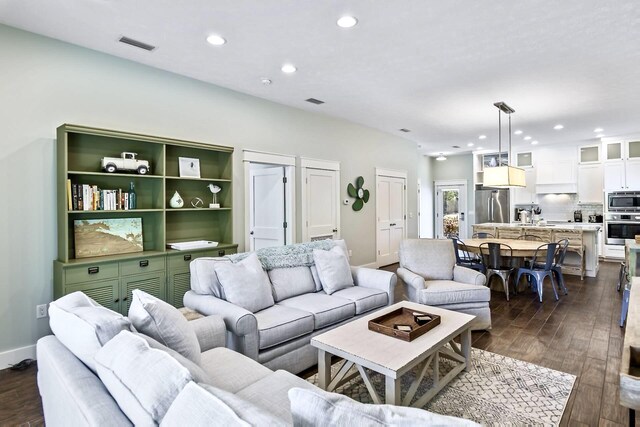 living room featuring dark wood-type flooring