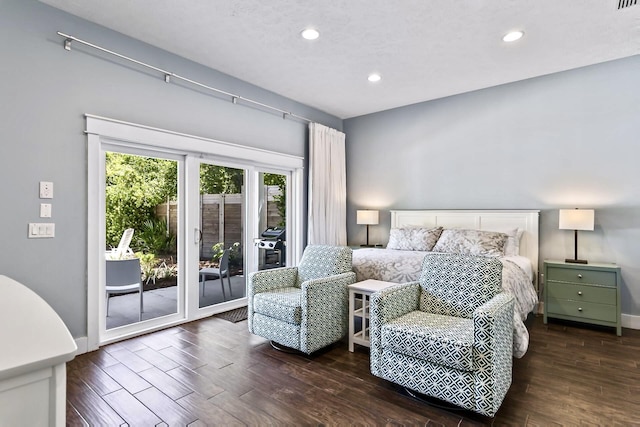 bedroom with access to outside and dark hardwood / wood-style flooring