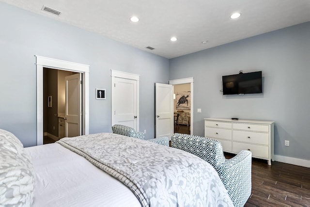 bedroom with dark hardwood / wood-style flooring