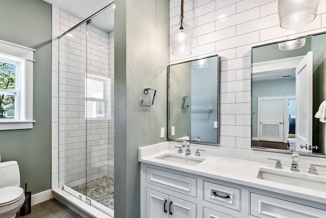 bathroom with vanity, tile patterned flooring, a shower with door, and toilet