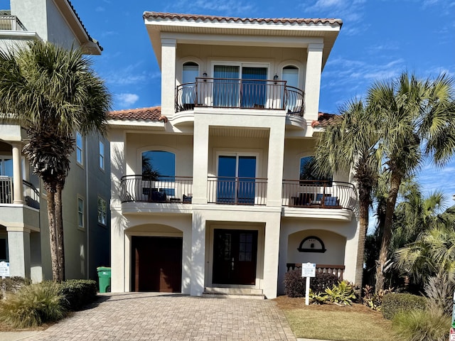 view of front of home with a balcony and a garage