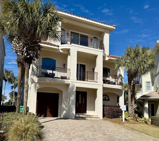 view of front of property with a garage and a balcony