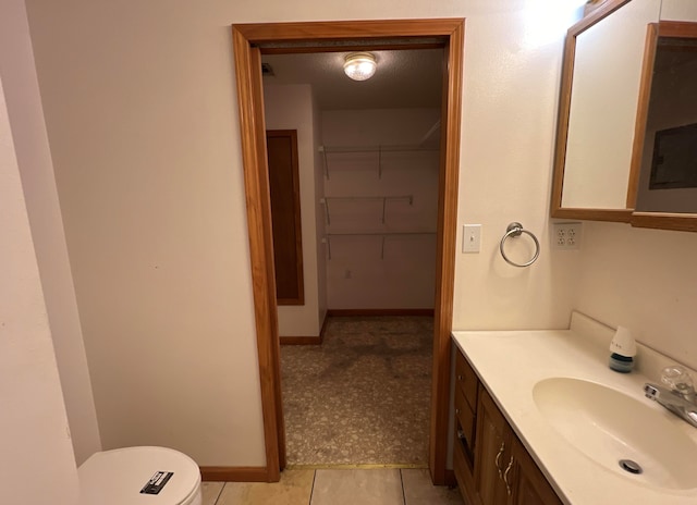 bathroom featuring oversized vanity, toilet, and tile floors