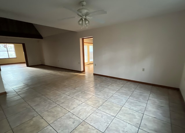 tiled spare room featuring ceiling fan