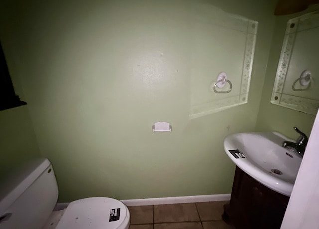 bathroom with vanity, toilet, and tile floors