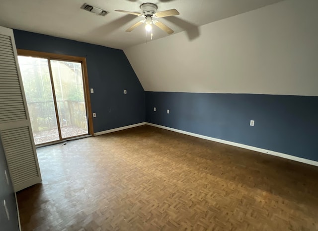 additional living space with lofted ceiling, ceiling fan, and dark parquet floors