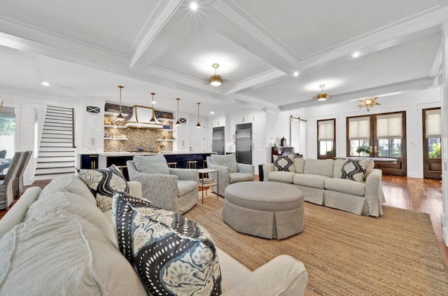 living room featuring plenty of natural light, beam ceiling, and light hardwood / wood-style flooring