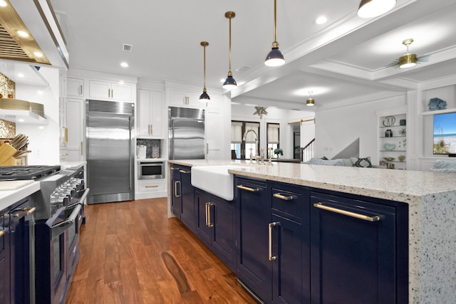 kitchen featuring white cabinetry, premium appliances, a kitchen island with sink, and ventilation hood