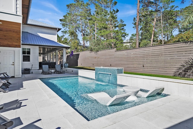 view of swimming pool featuring a patio and pool water feature