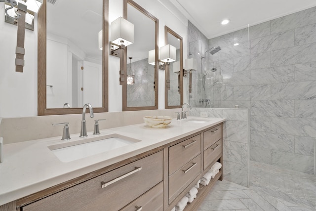 bathroom with tiled shower and vanity