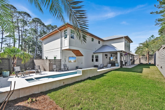 back of property with a yard and a patio