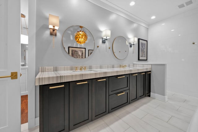 bathroom featuring ornamental molding and vanity