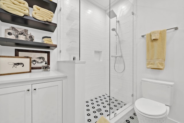 bathroom with a shower with shower door and toilet