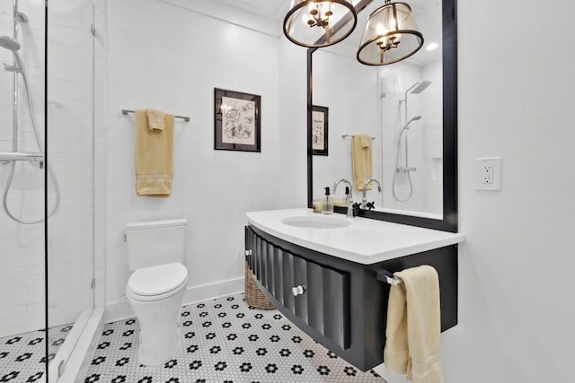 bathroom with tiled shower, vanity, toilet, and tile patterned flooring