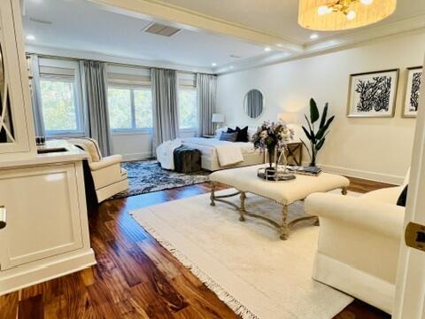 bedroom featuring crown molding and dark hardwood / wood-style floors