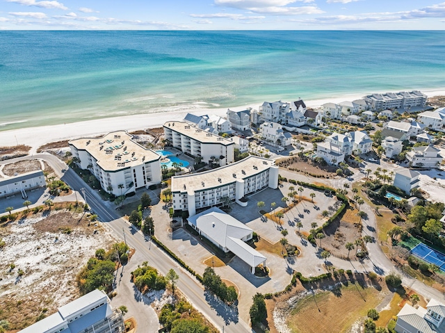 birds eye view of property with a water view and a view of the beach