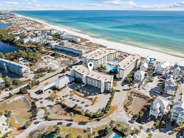 birds eye view of property featuring a water view and a beach view