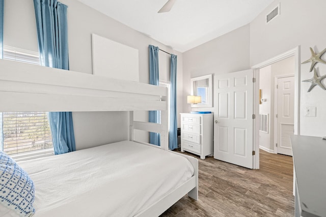 bedroom featuring ceiling fan, lofted ceiling, and hardwood / wood-style flooring