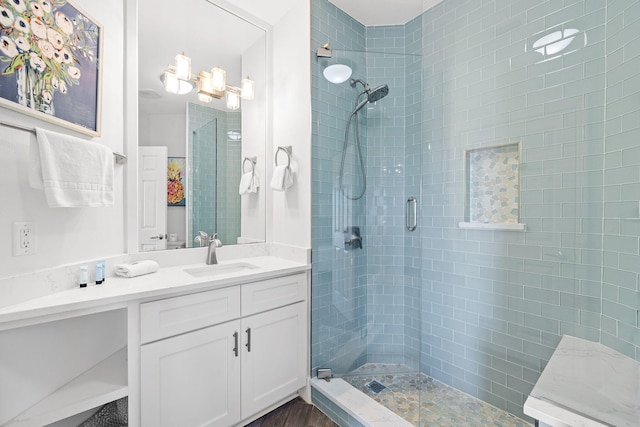 bathroom with an enclosed shower and vanity