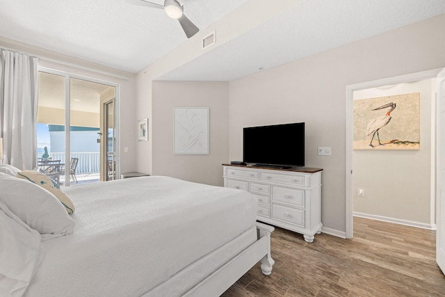 bedroom featuring ceiling fan, access to exterior, and wood-type flooring