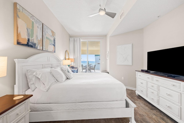 bedroom with ceiling fan, access to exterior, dark wood-type flooring, and a textured ceiling